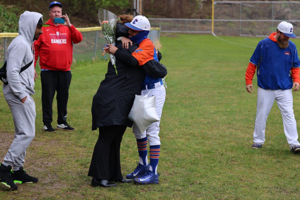 baseball player hugs parent
