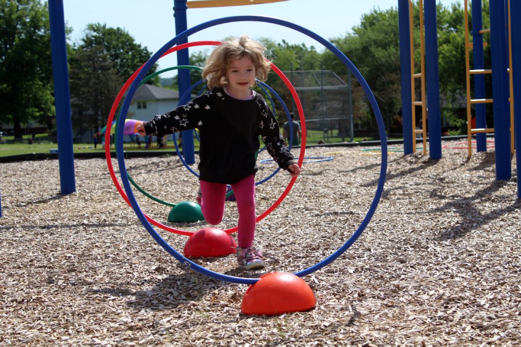 girl running through hoops