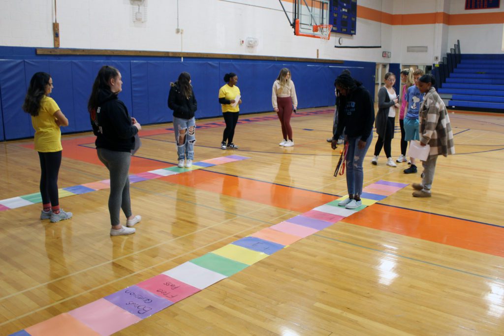students playing game on gym floor