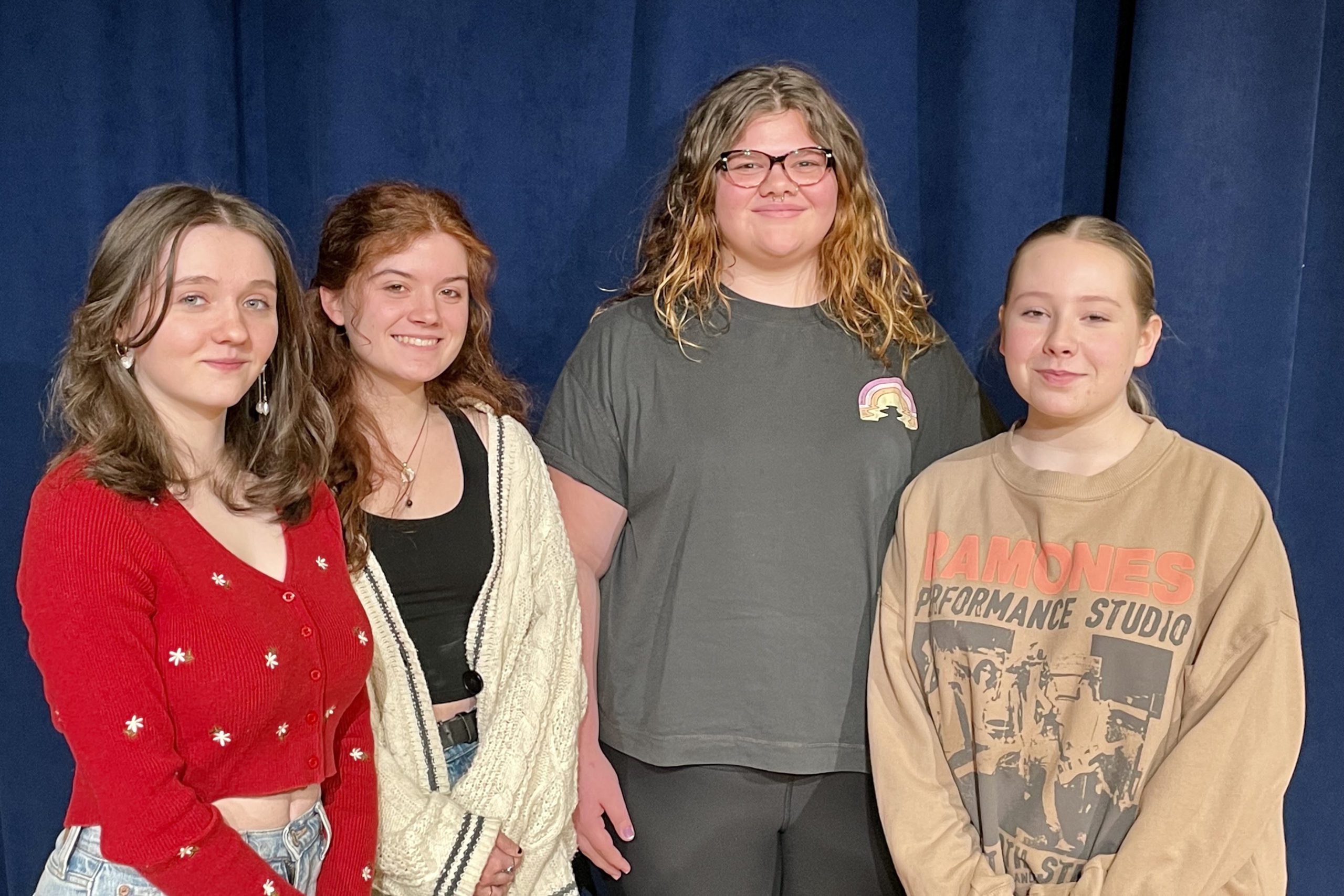 four high school girls smiling