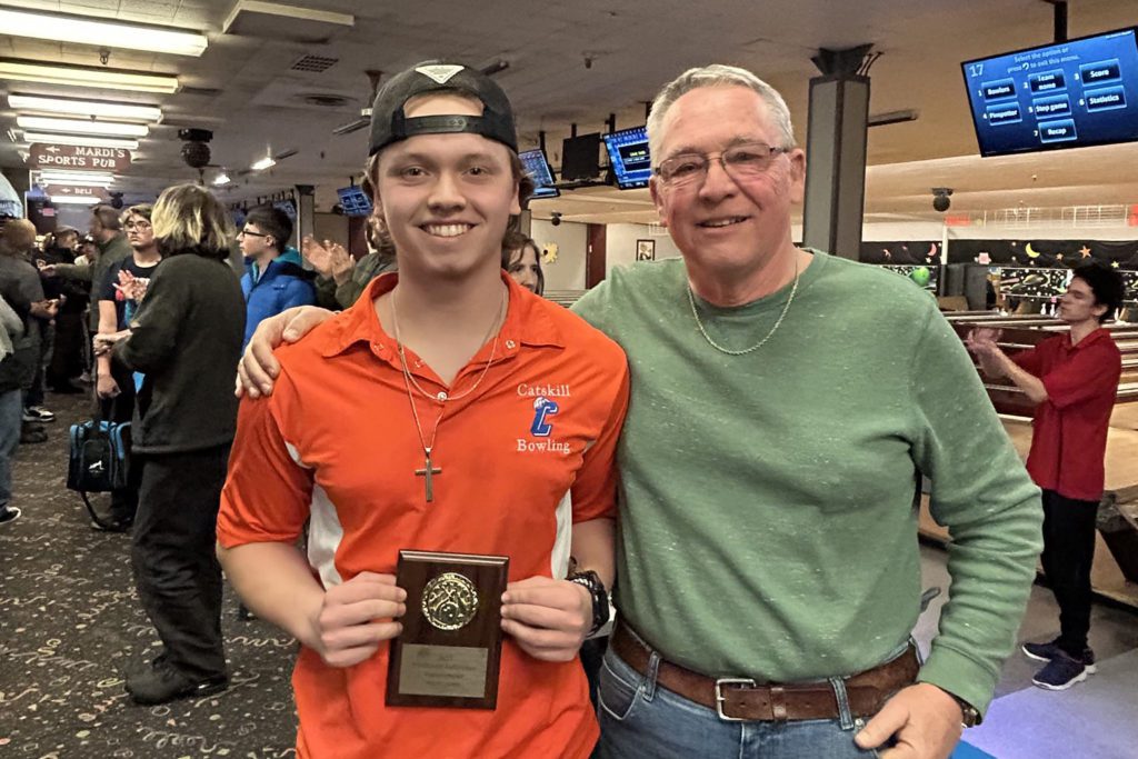 Nick Place with man and high game award plaque 