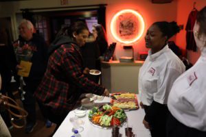 students serving refreshments