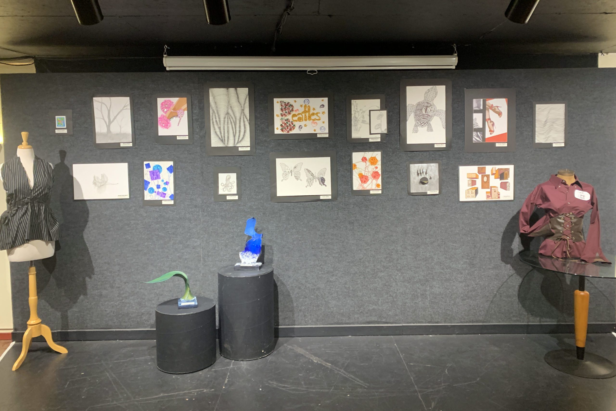 student drawings, sculpture, and fashion on display