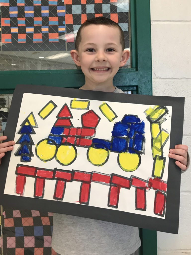 boy holding drawing of train