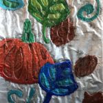 elementary school artwork depicting pumpkin and fall leaves