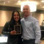 Girl and coach pose with Scholar Athlete plaque.