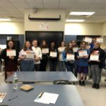 students pose with certificates