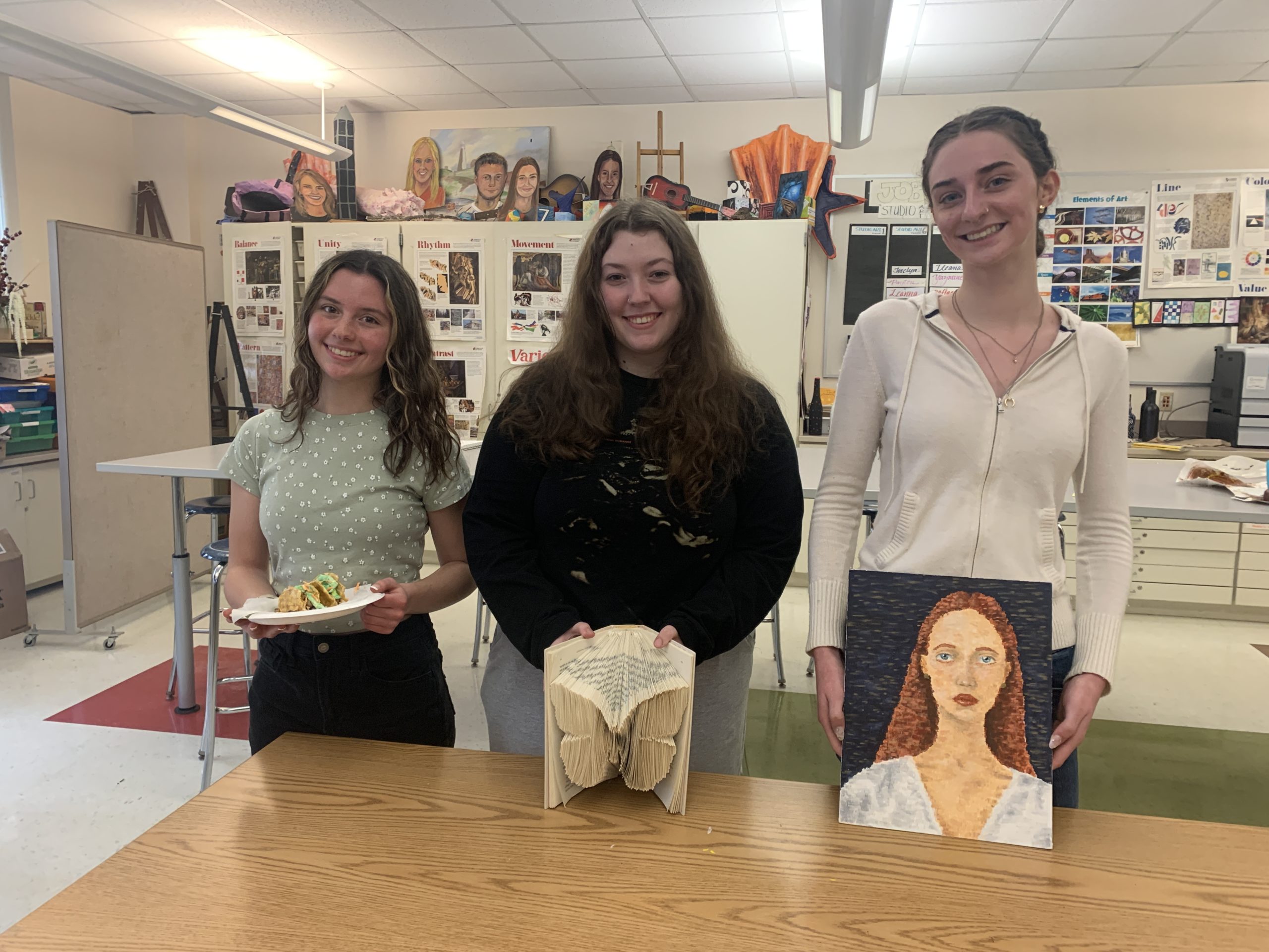 three girls standing with art