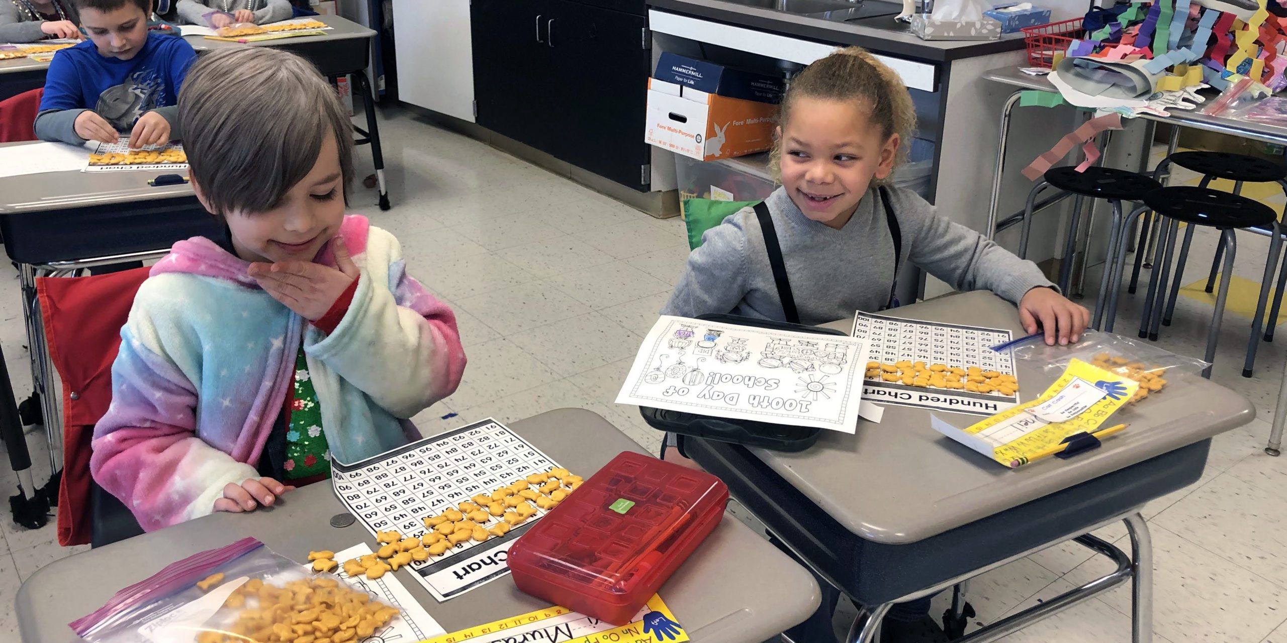 two students counting goldfish crackers