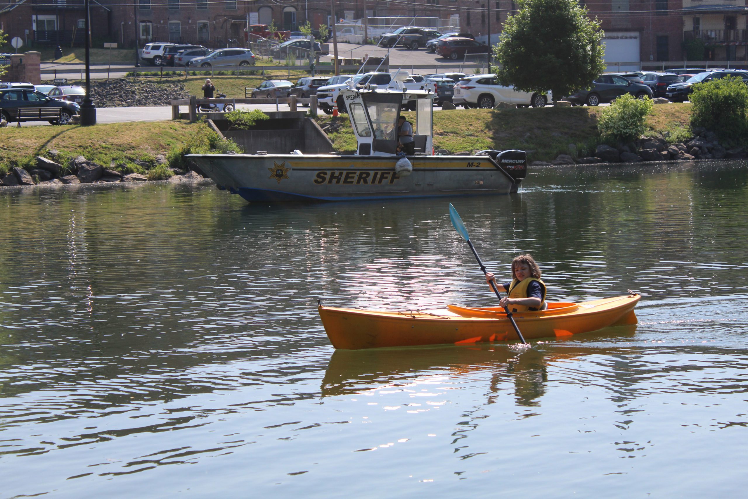 student paddling kayak