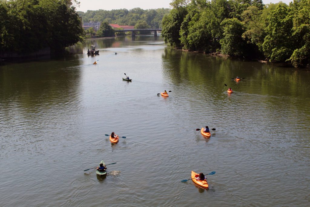 students paddling kayaks down Catskill Creek