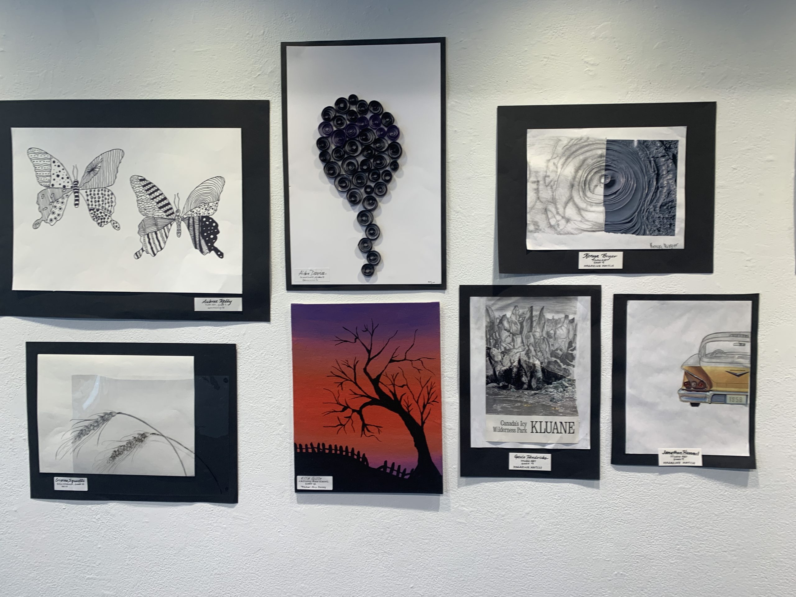 student paintings on gallery wall