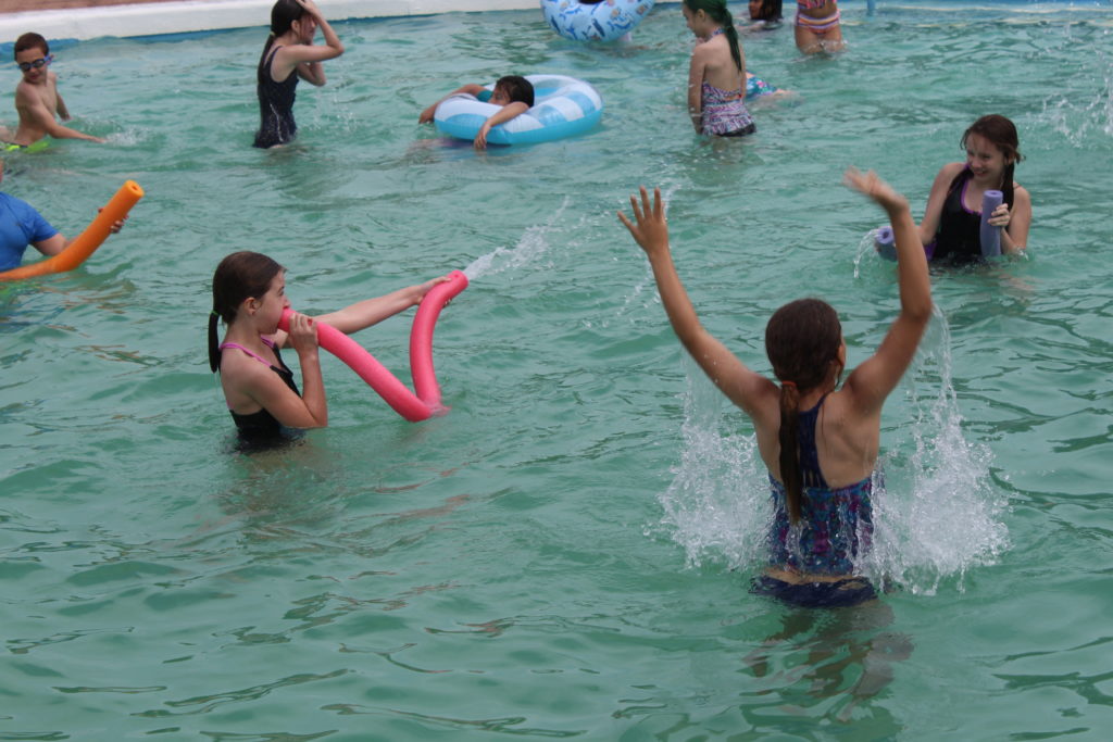 students swimming in pool