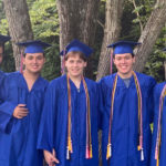 Konsul Quadruplets and their cousin in graduation caps and gowns.