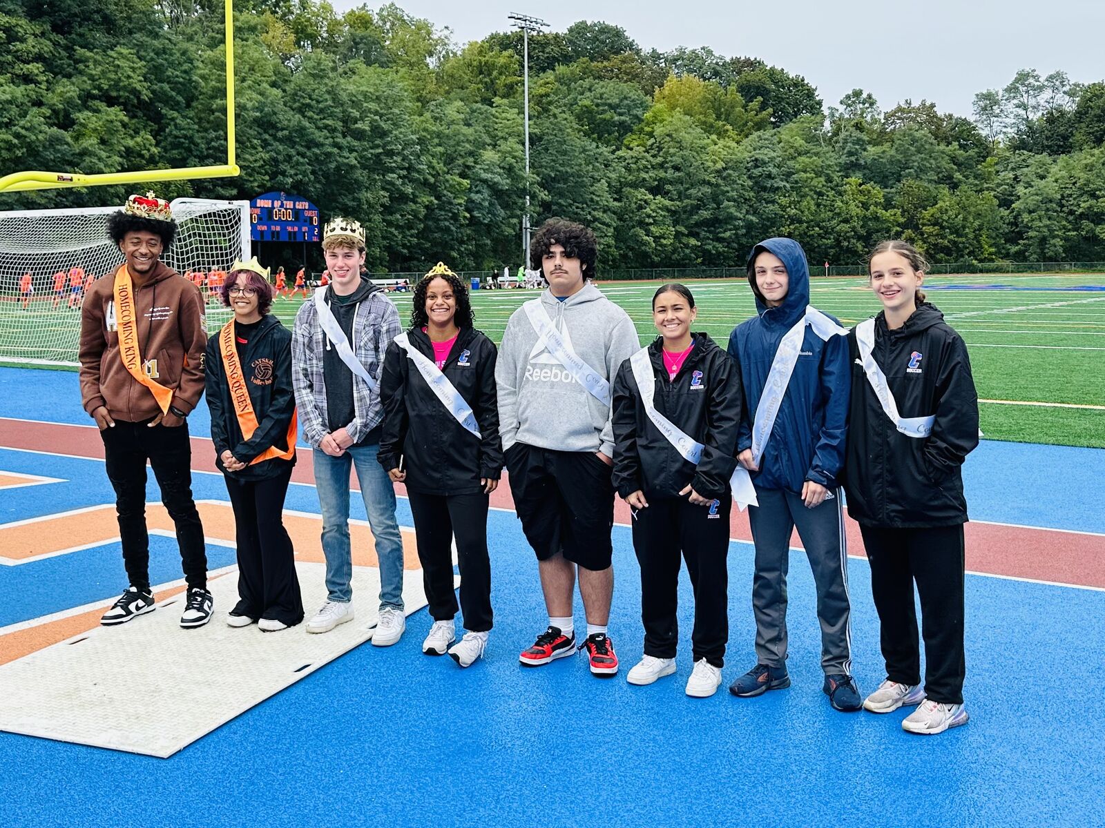 Catskill High School 2023 homecoming court in crowns and sashes on football field.