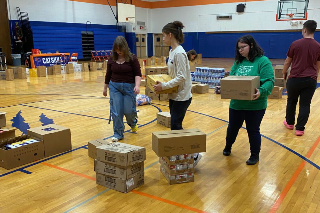 students carrying boxes of food
