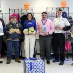 VFW and school officials pose with books and other donated items in Cats Care Room