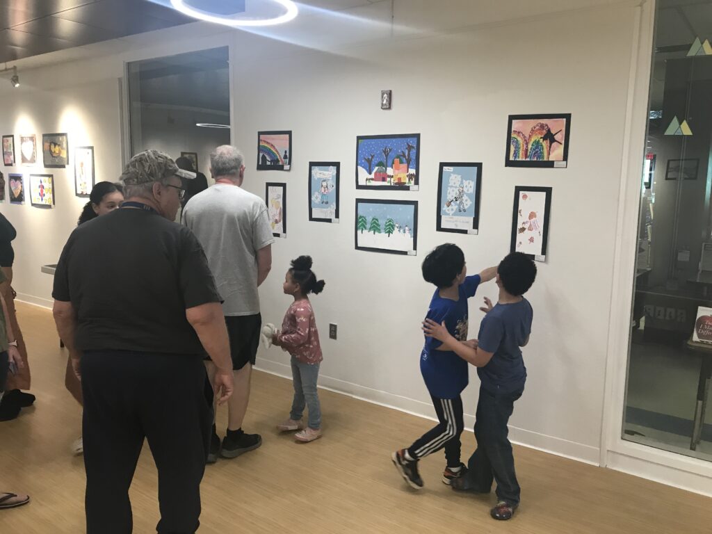 boy pointing to painting on wall