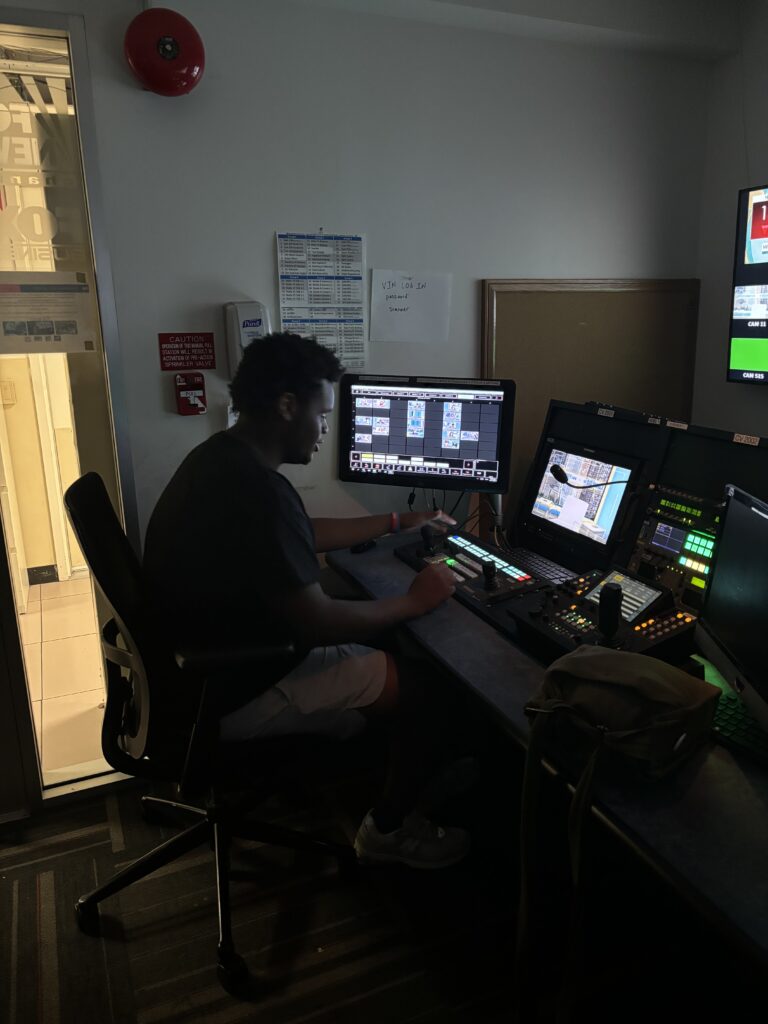 teenage boy sitting at studio controls .