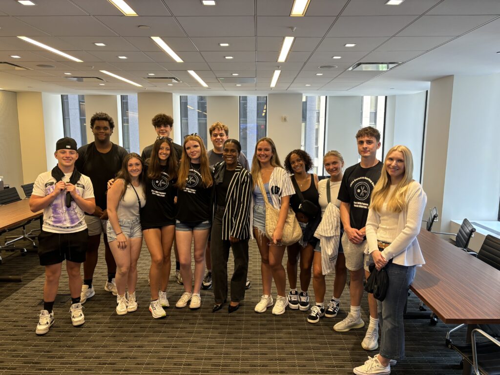 students pose for photo with NY Green Bank vice president.