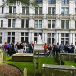 students pose for photo in Trinity Church graveyard.