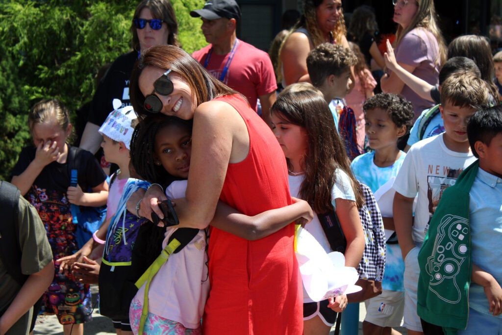 girl hugging staff member
