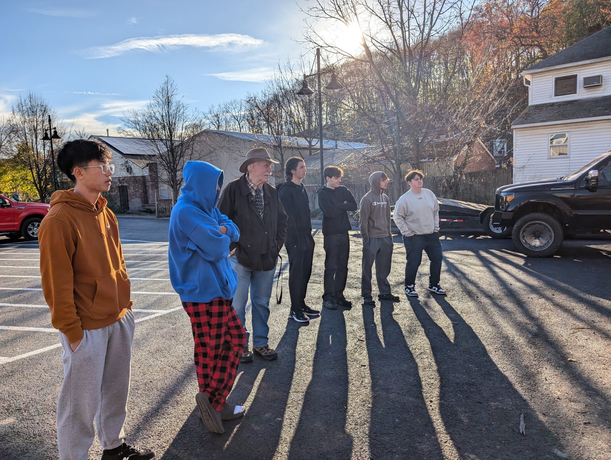 students and staff watching sawmill being used