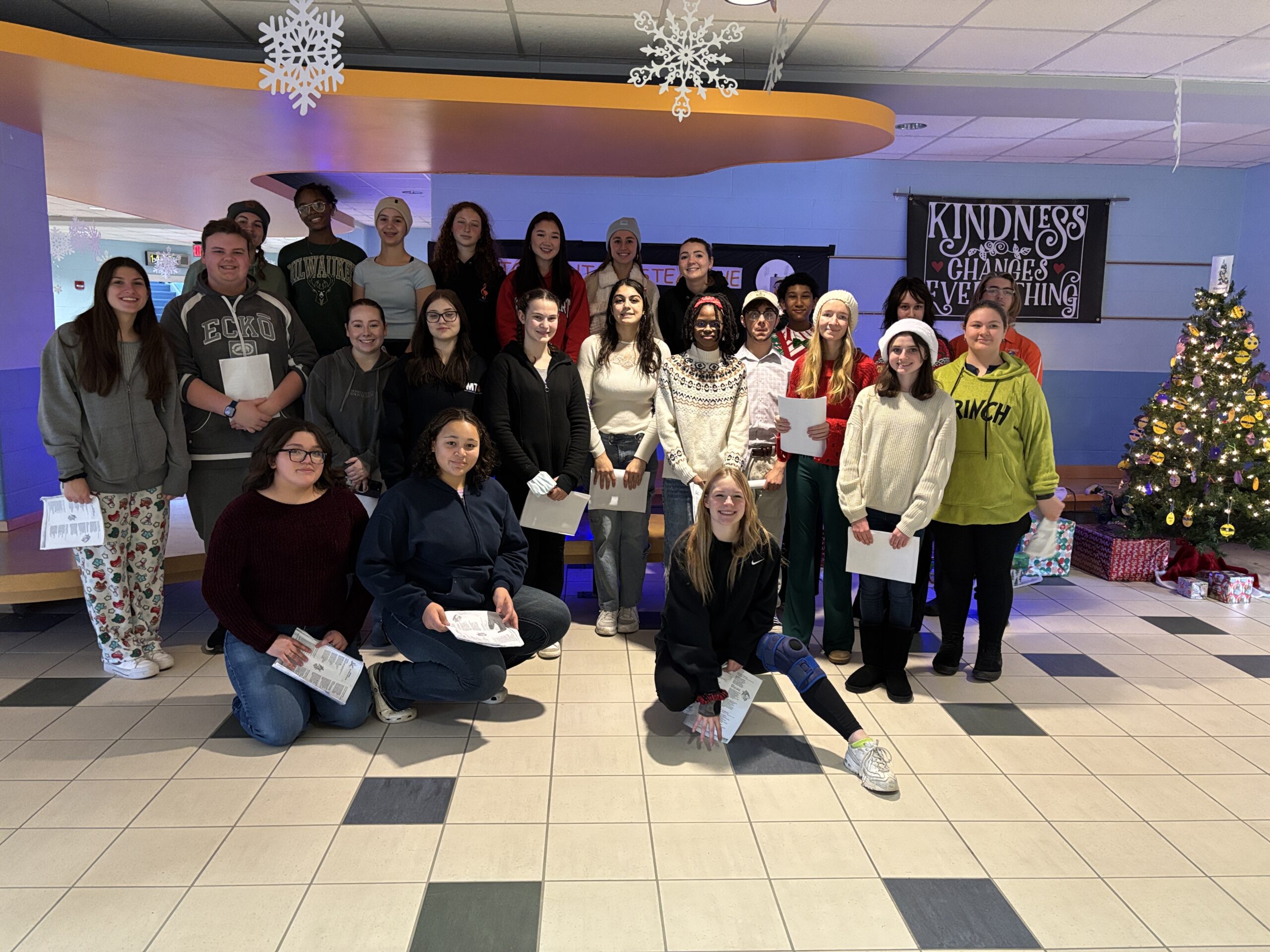 students pose for photo in CES Atrium
