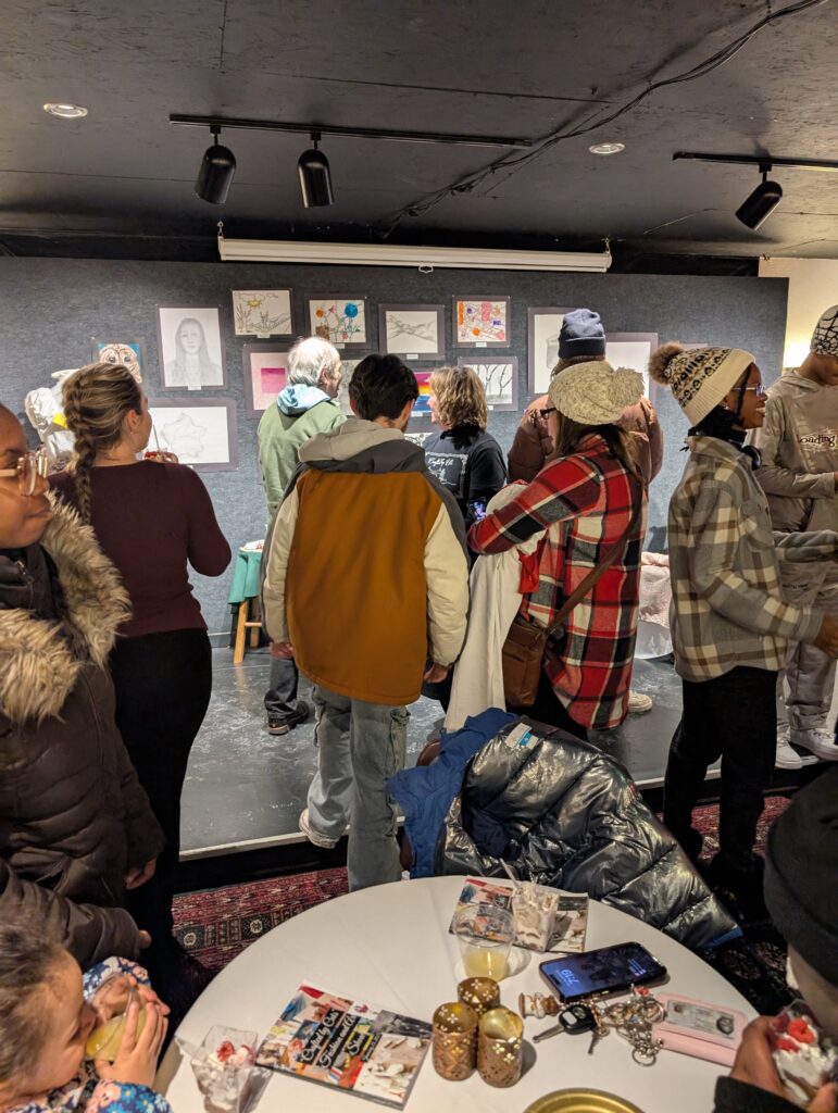 crowd looking at gallery artwork