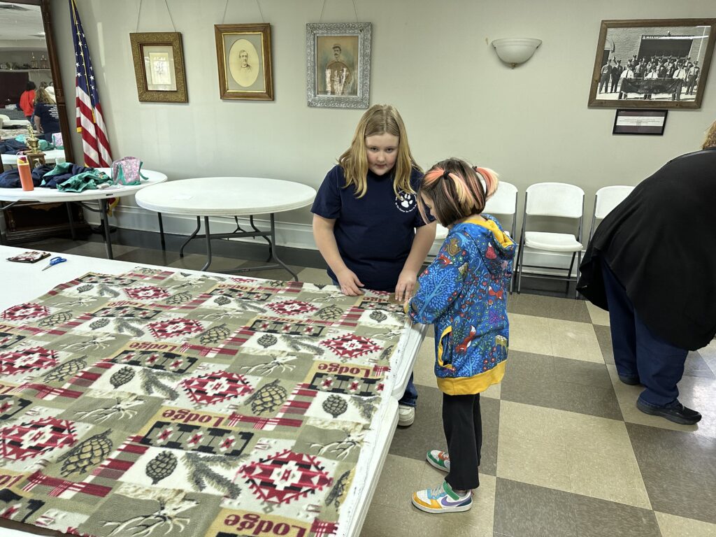 girls working on blanket