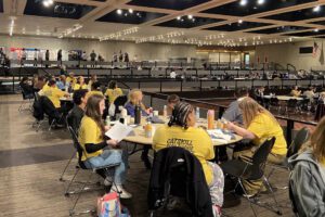 students seated at Empire Plaza convention centert