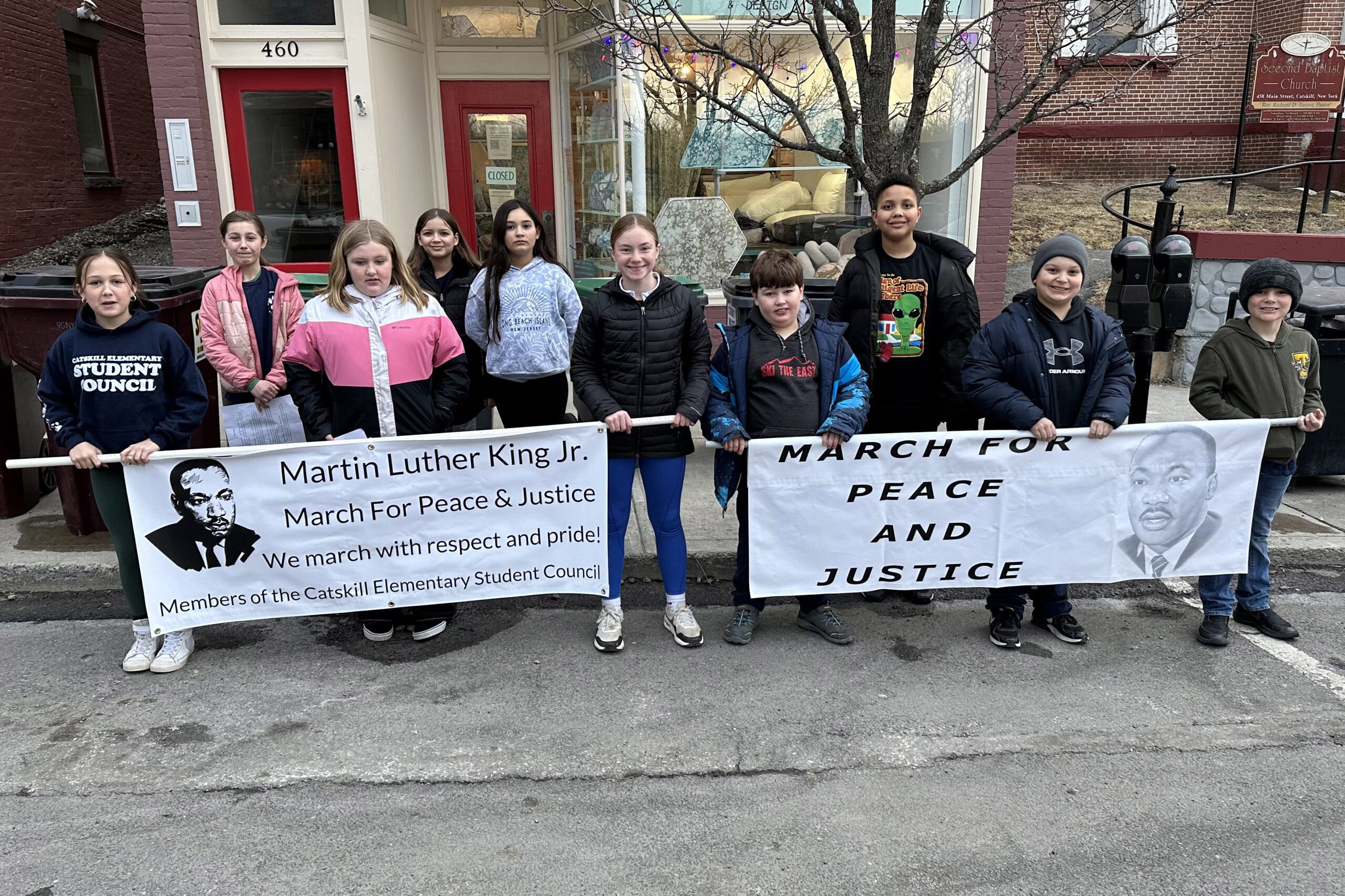 students holding Martin Luther King Jr. Banner and March for Peace and Justice banner