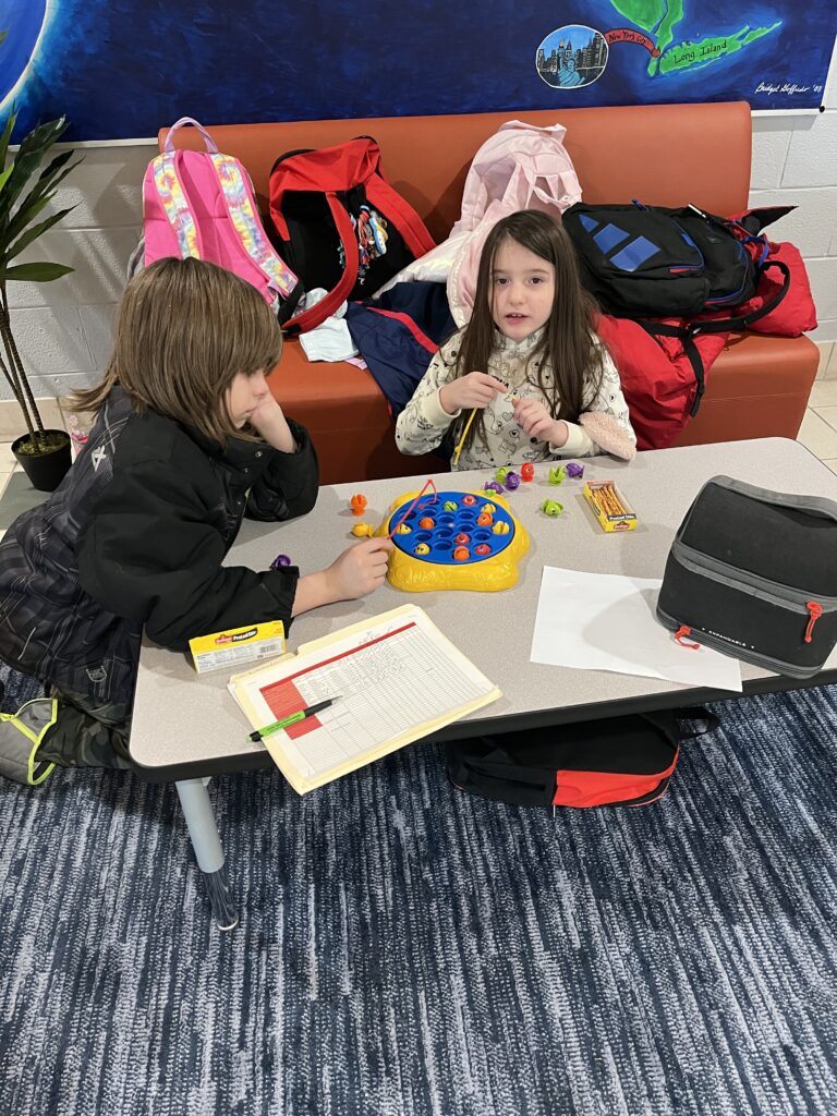students playing fishing board game