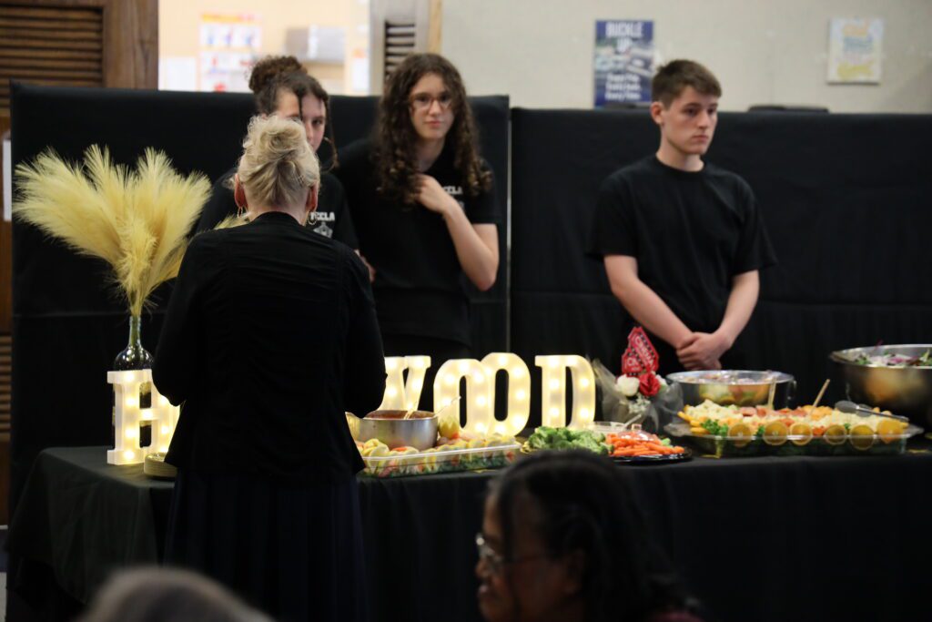 students manning table