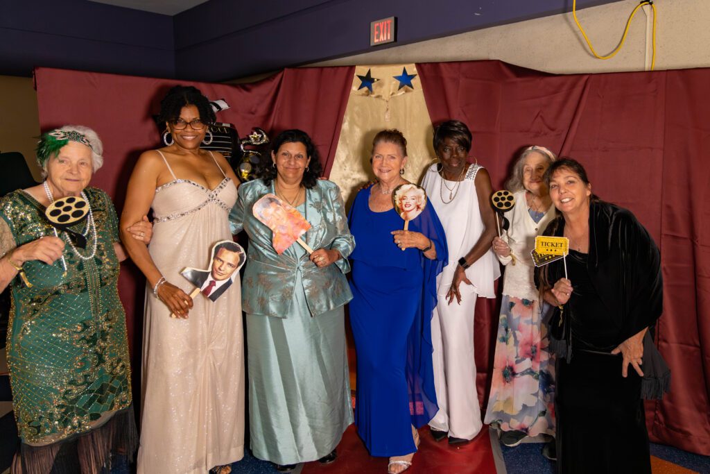 six women in prom dresses