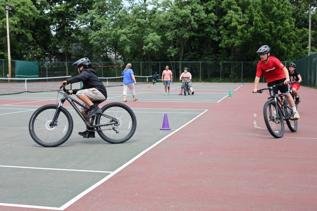 boys riding mountain bikes on tennis court