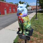 cat statue with barnyard theme in front of high school