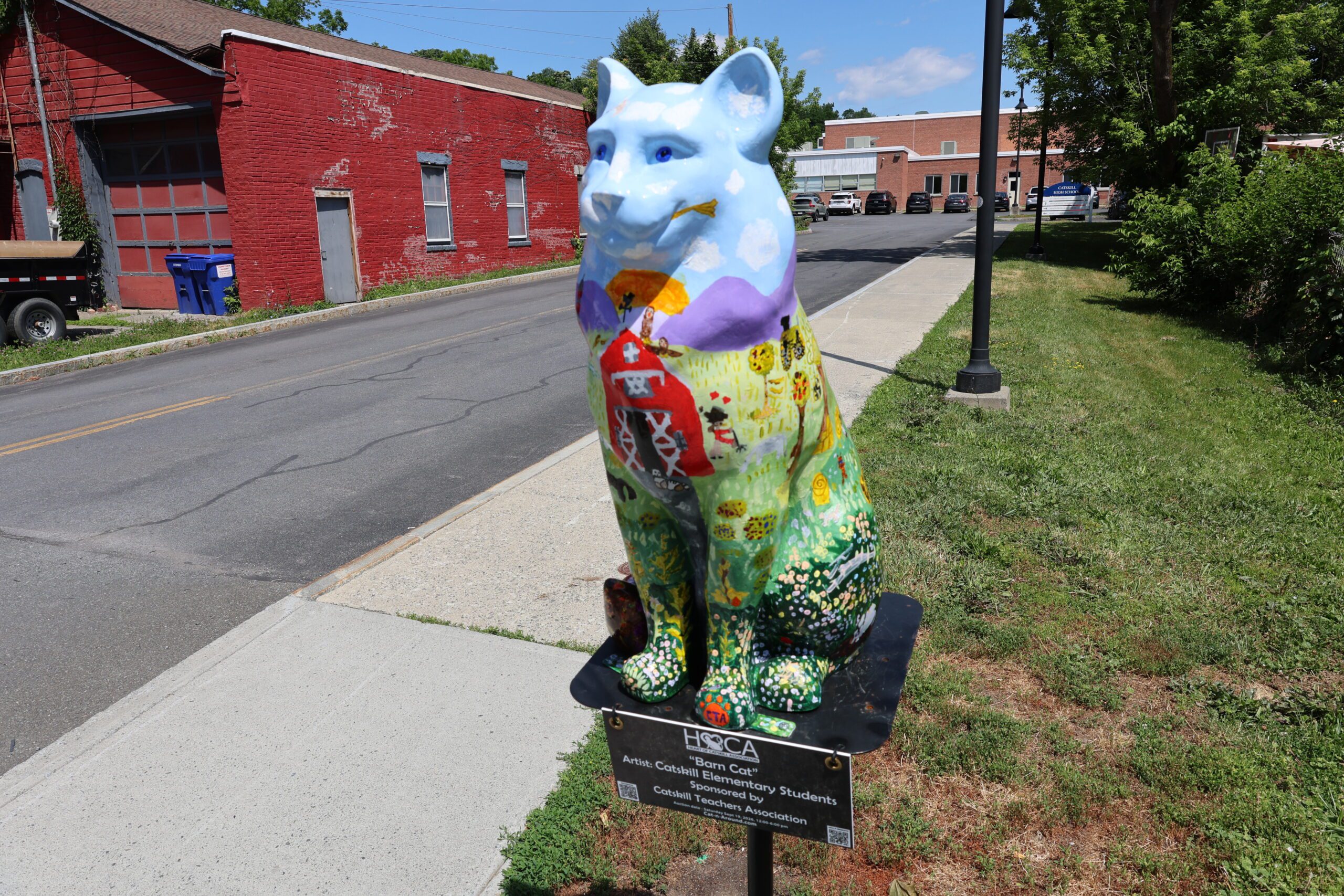cat statue with barnyard theme in front of high school