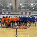 orange and blu alumni teams pose for group photo in gym
