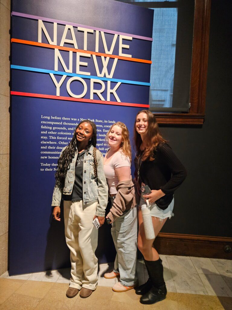Native-New-York-Students-Posing-in-Front-of-Native-New-York-Sign