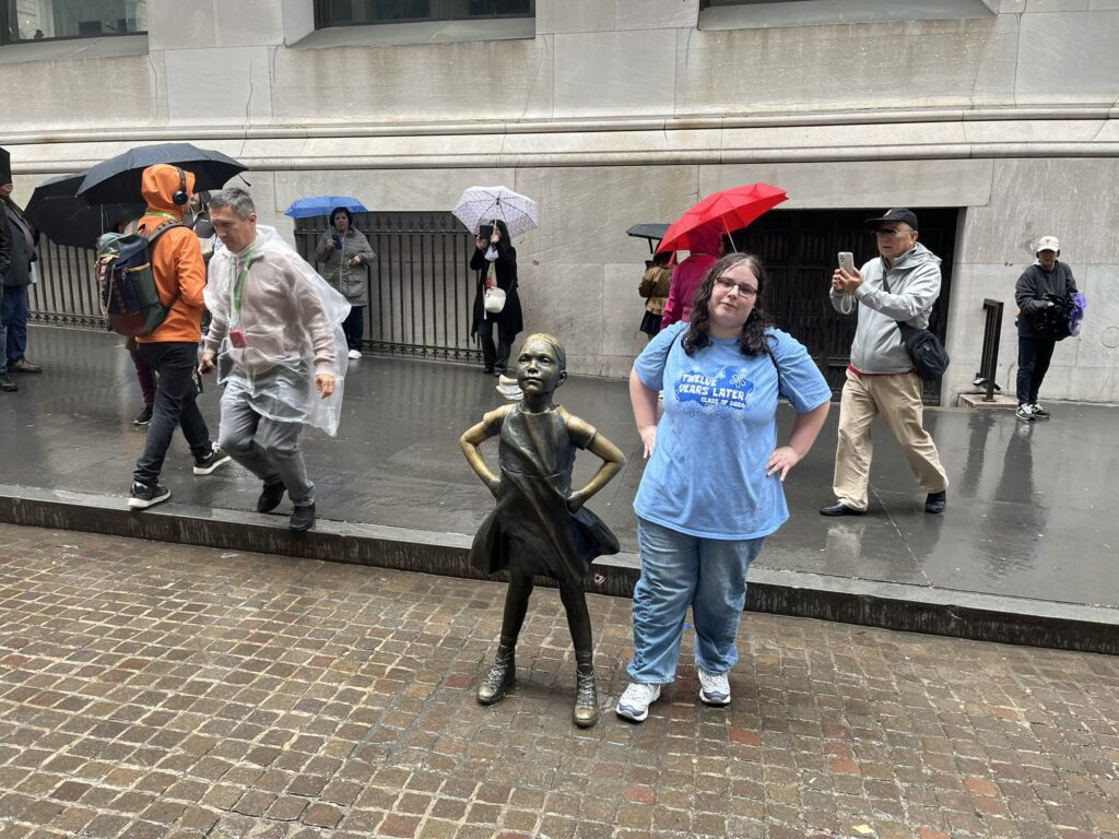 Zoey-Standing-Fearlessly-in-the-Rain-with-the-Fearless-Girl
