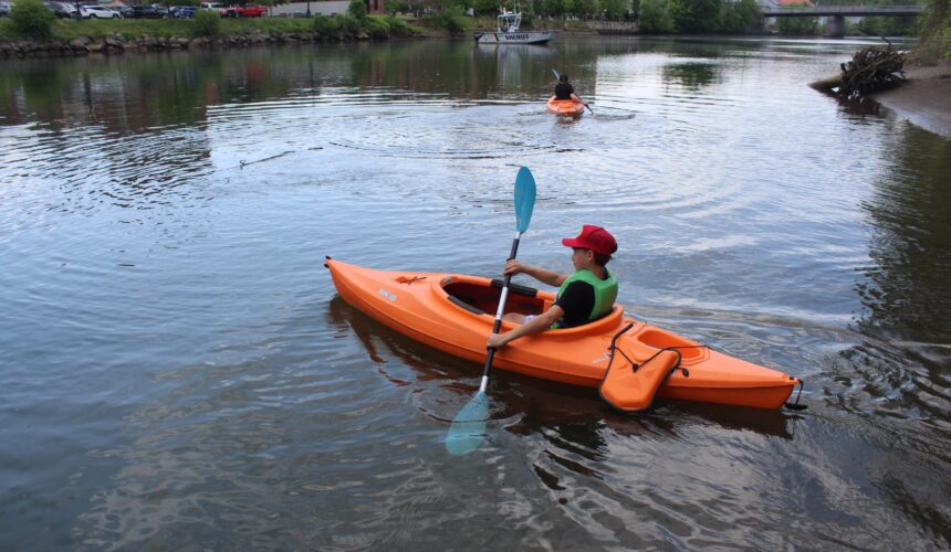 boy in kayak on creek